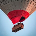 a large hot air balloon flying through a blue sky